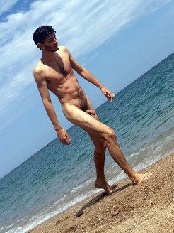 Slender dude naked on the beach