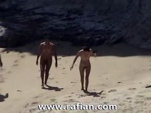 African and white women sunbathing on nude...