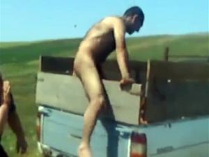 Nude farmer gets pantsed in the field