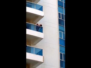Voyeur video where couple fucks on balcony