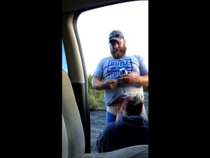 Fat guy with gun gets blowjob near the car