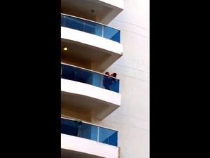 Voyeur of couple on balcony