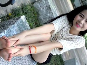 Cute chinese teen shows her feet outdor