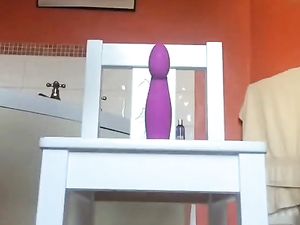 Louise rides a purple dildo on a chair