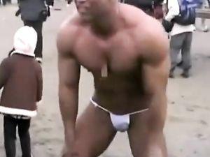 Asian bodybuilder barely covered at the beach