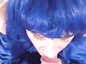 Blue wig crossdresser blowing