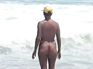 White beach, blue sea, topless girl