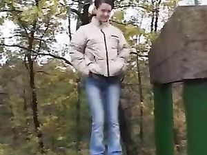 Young girl peeing in a park
