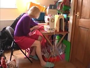 Blonde MILF masturbating in between sewing